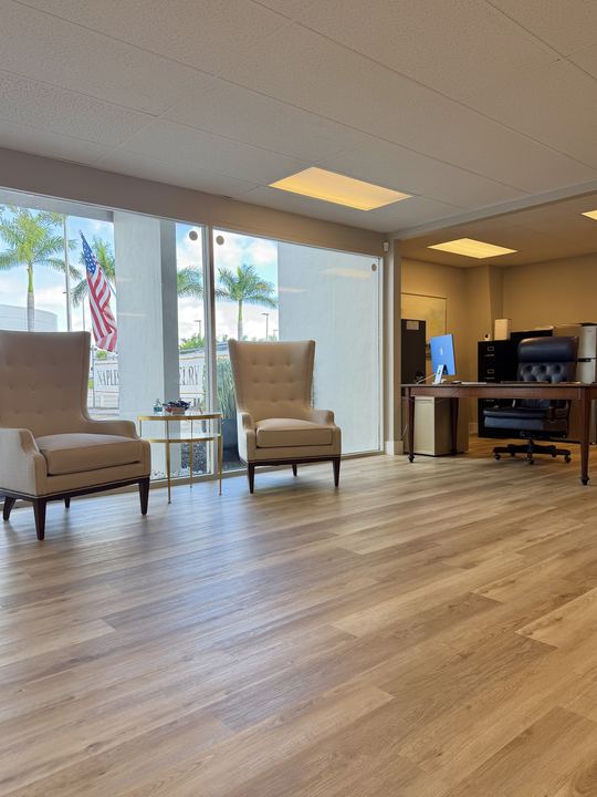 Wingback chairs by the front windows of the Covenant office